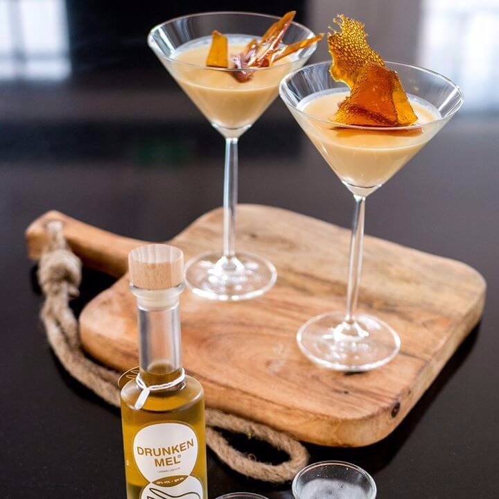 Houten plank met 2 cocktail glazen met pannacotta